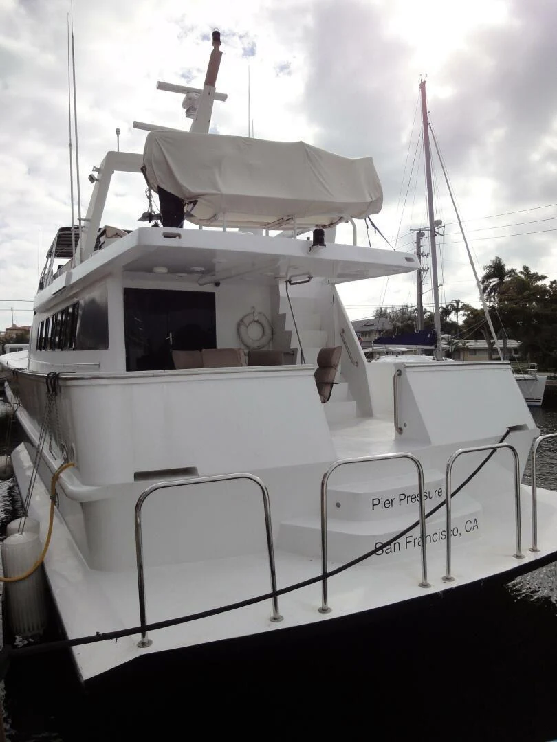 a white boat with a white deck aboard PIER PRESSURE Yacht for Sale