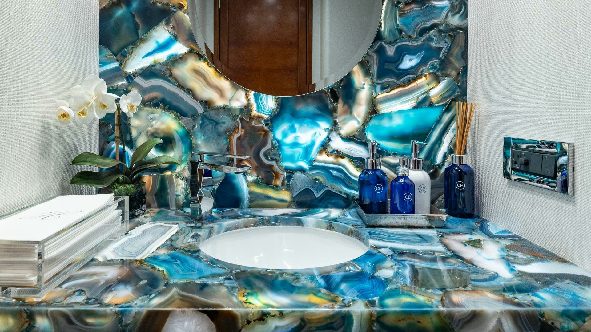 a blue table with a white plate and a white bowl with blue liquid in it aboard NO SHORTCUTS Yacht for Sale