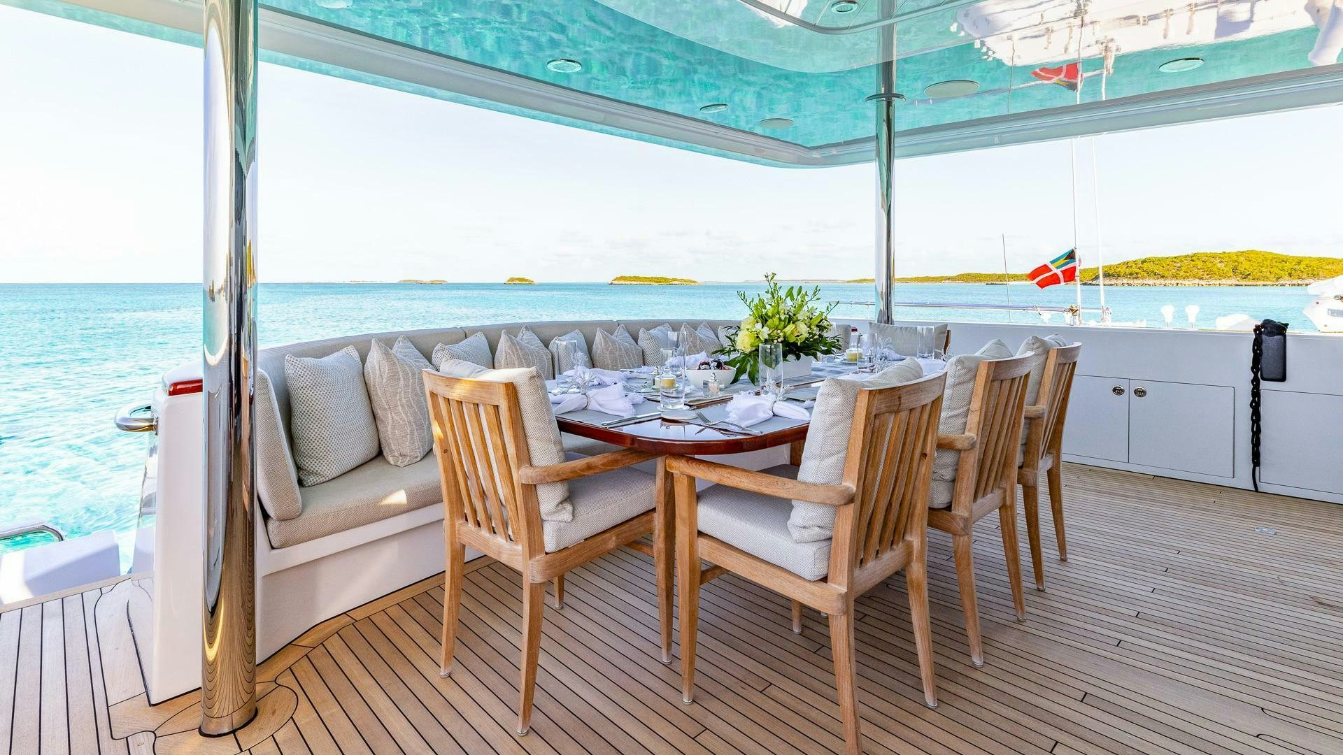 a table and chairs on a deck aboard NO SHORTCUTS Yacht for Sale
