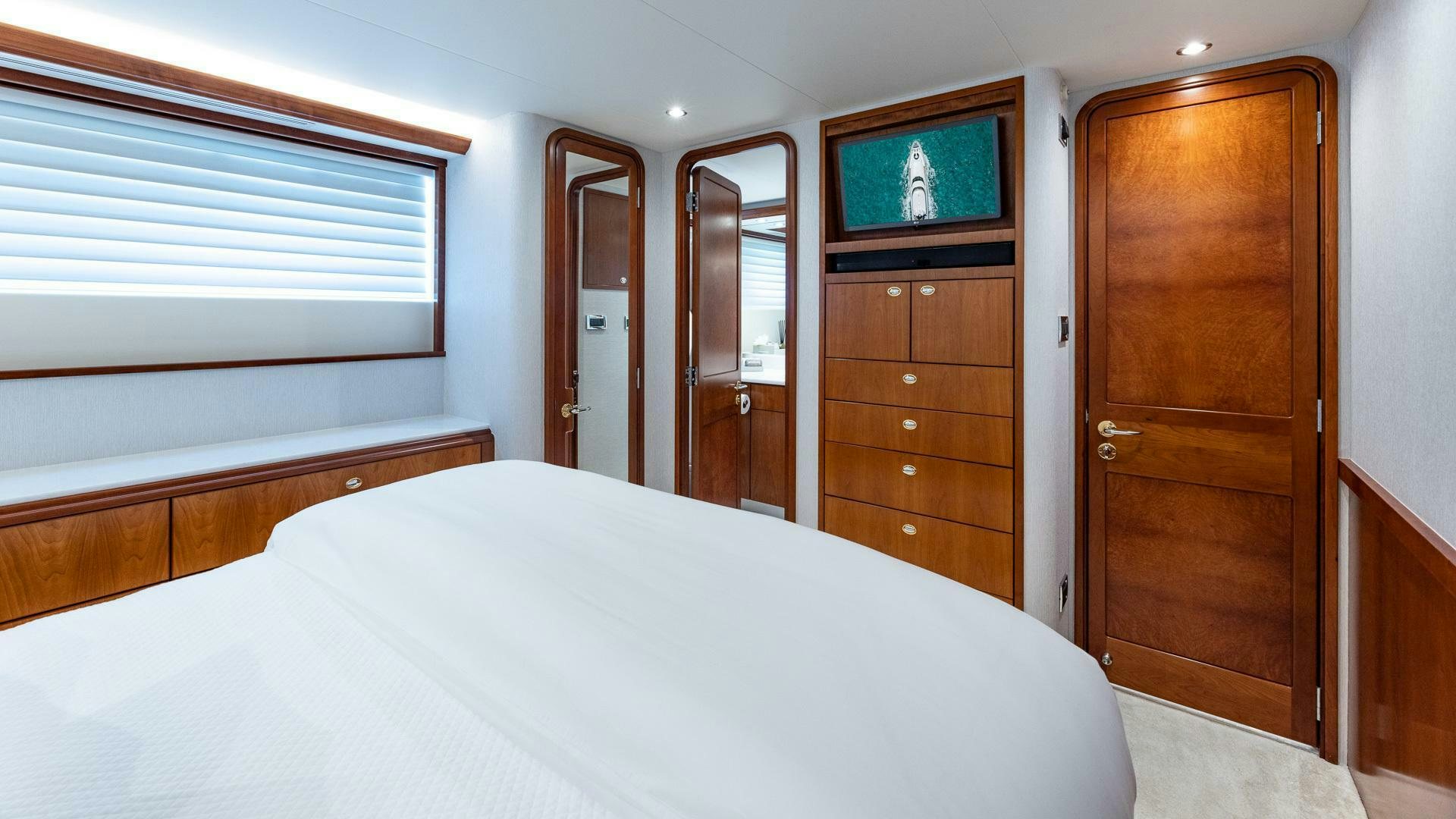 a hotel room with a television and a bed aboard NO SHORTCUTS Yacht for Sale