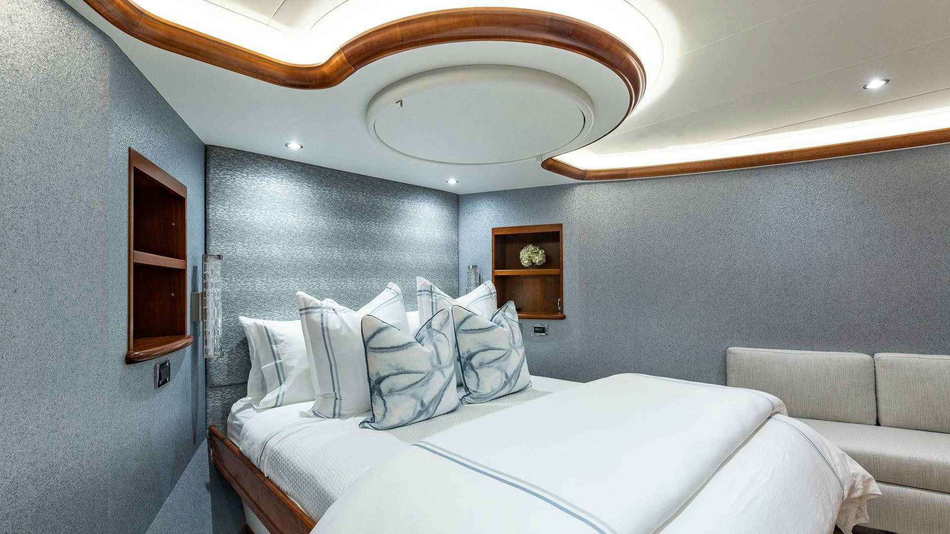 a room with a bed and a mirror aboard NO SHORTCUTS Yacht for Sale