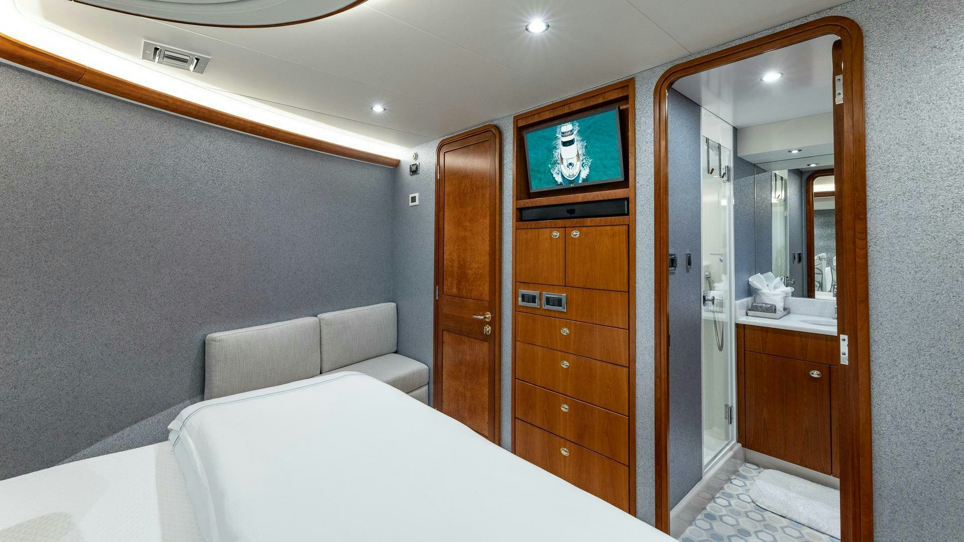 a hotel room with a bed and a tv on the wall aboard NO SHORTCUTS Yacht for Sale
