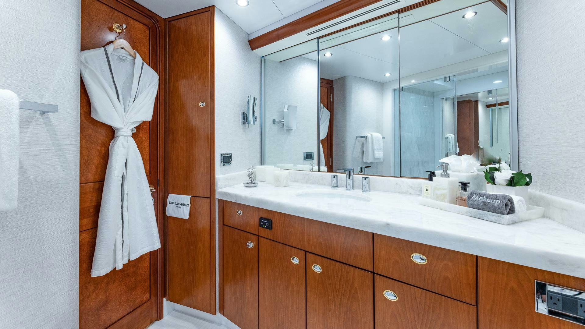 a bathroom with a robe on the wall aboard NO SHORTCUTS Yacht for Sale