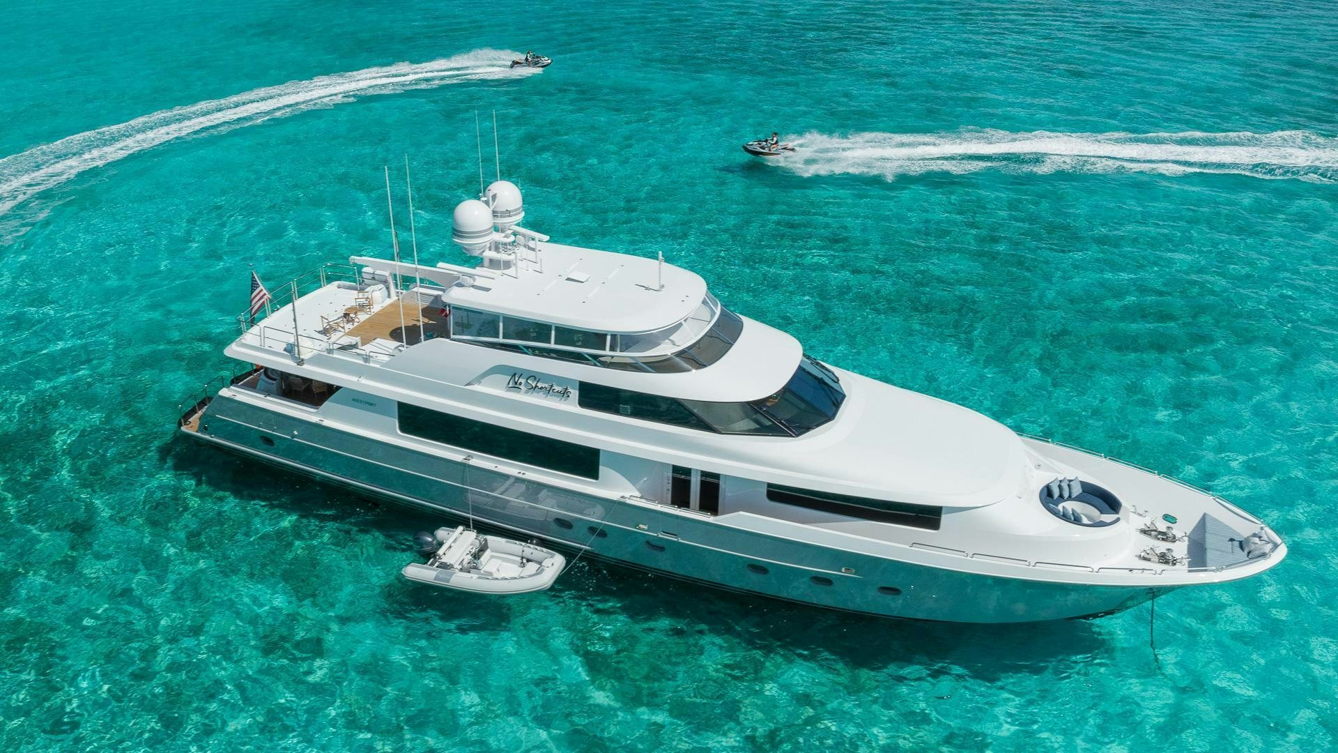a white yacht on the water aboard NO SHORTCUTS Yacht for Sale