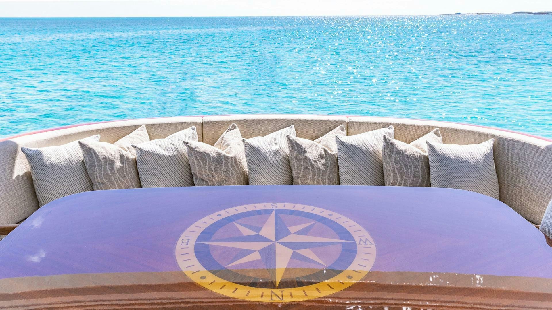 a couch with pillows and a rug on it aboard NO SHORTCUTS Yacht for Sale