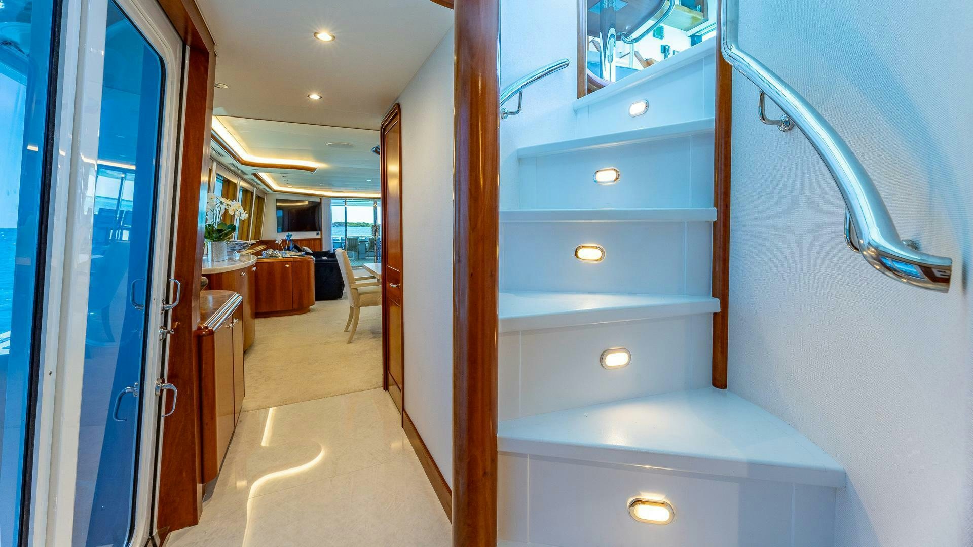 a room with a door and a table with chairs and a window aboard NO SHORTCUTS Yacht for Sale