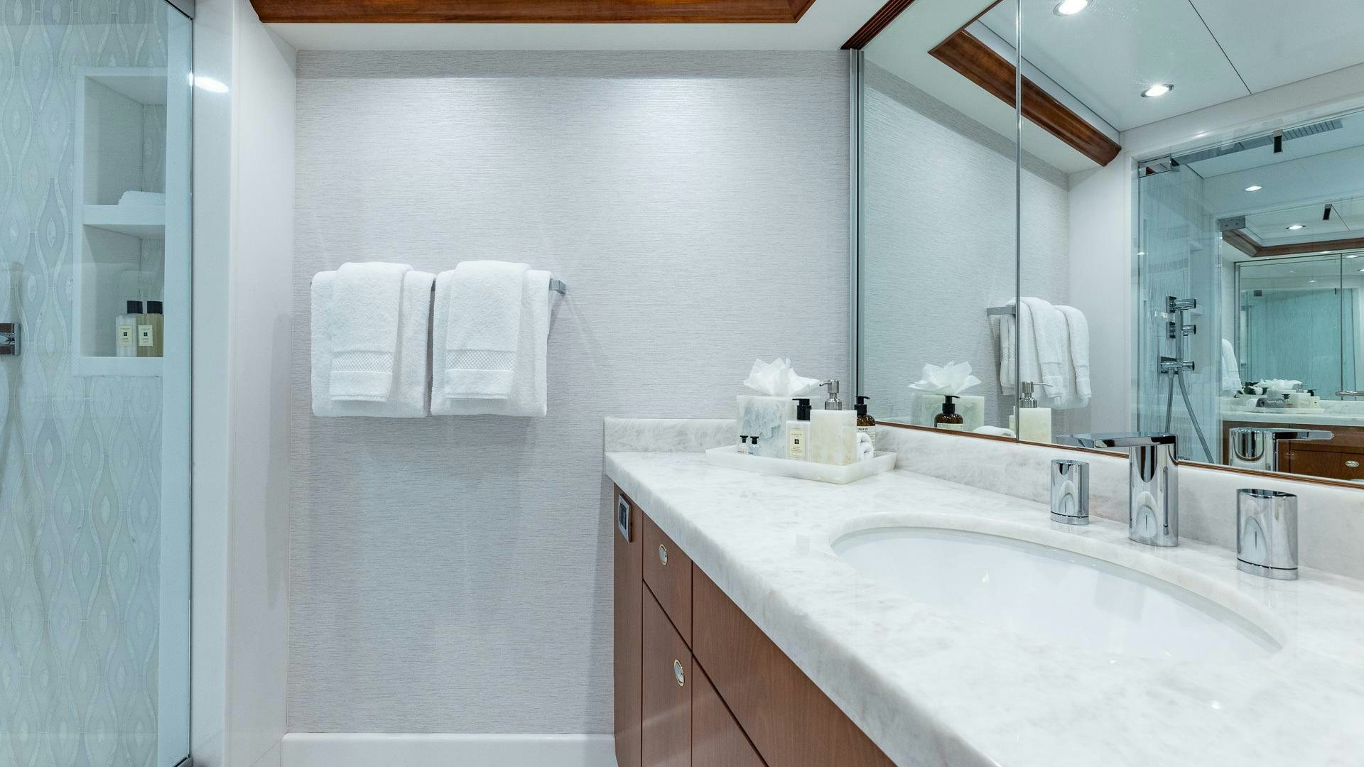 a bathroom with a large mirror aboard NO SHORTCUTS Yacht for Sale