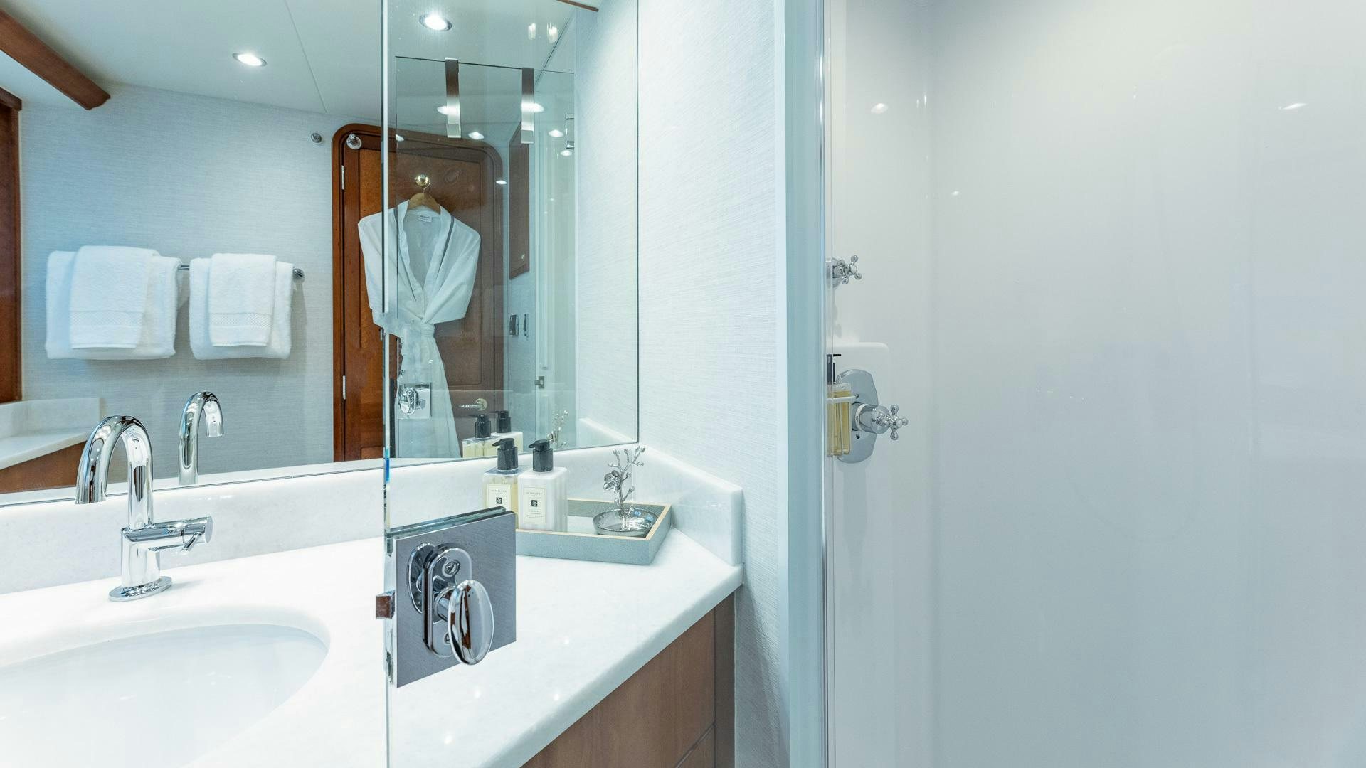 a bathroom with a large mirror aboard NO SHORTCUTS Yacht for Sale