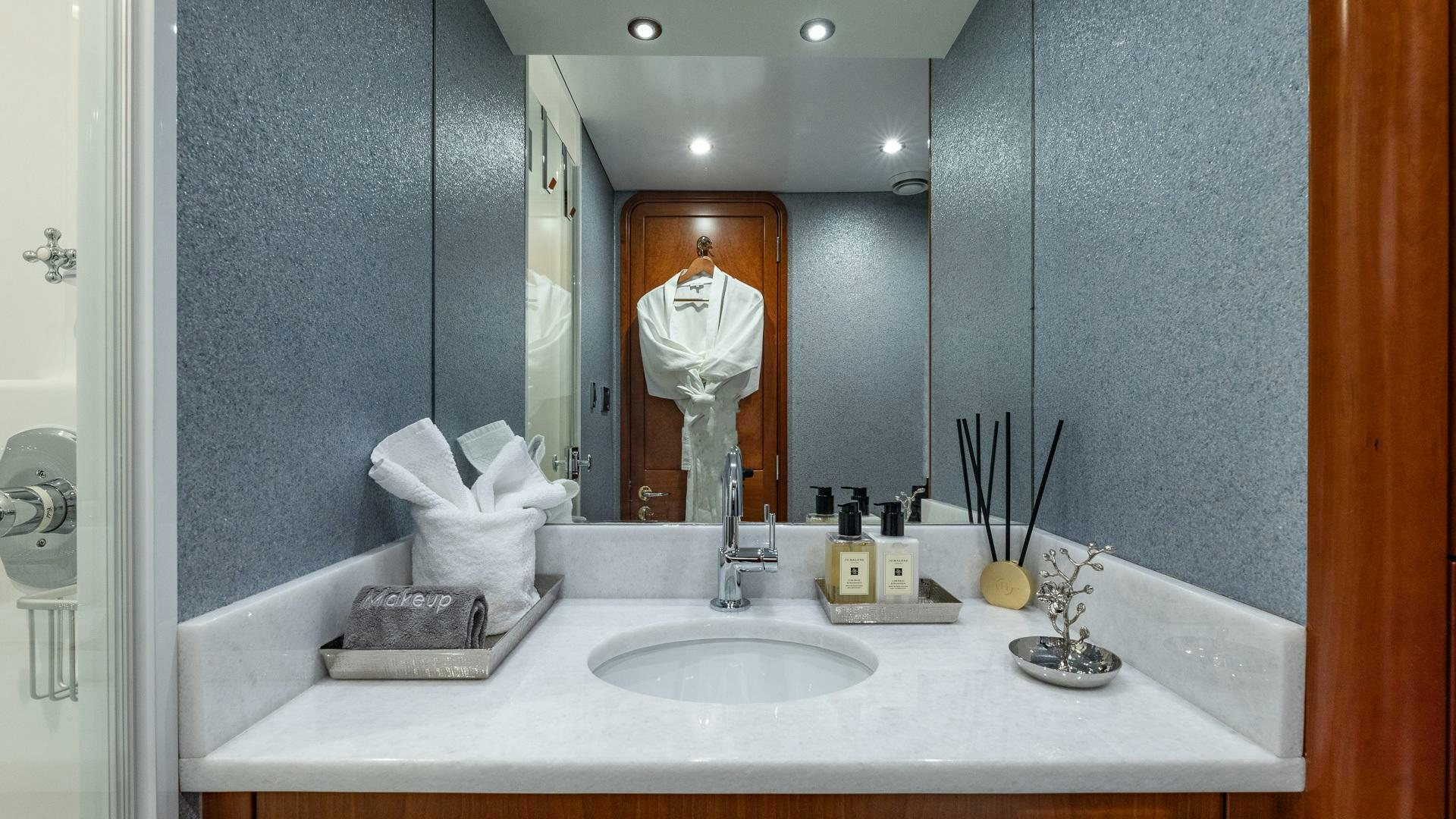 a bathroom with a large mirror aboard NO SHORTCUTS Yacht for Sale