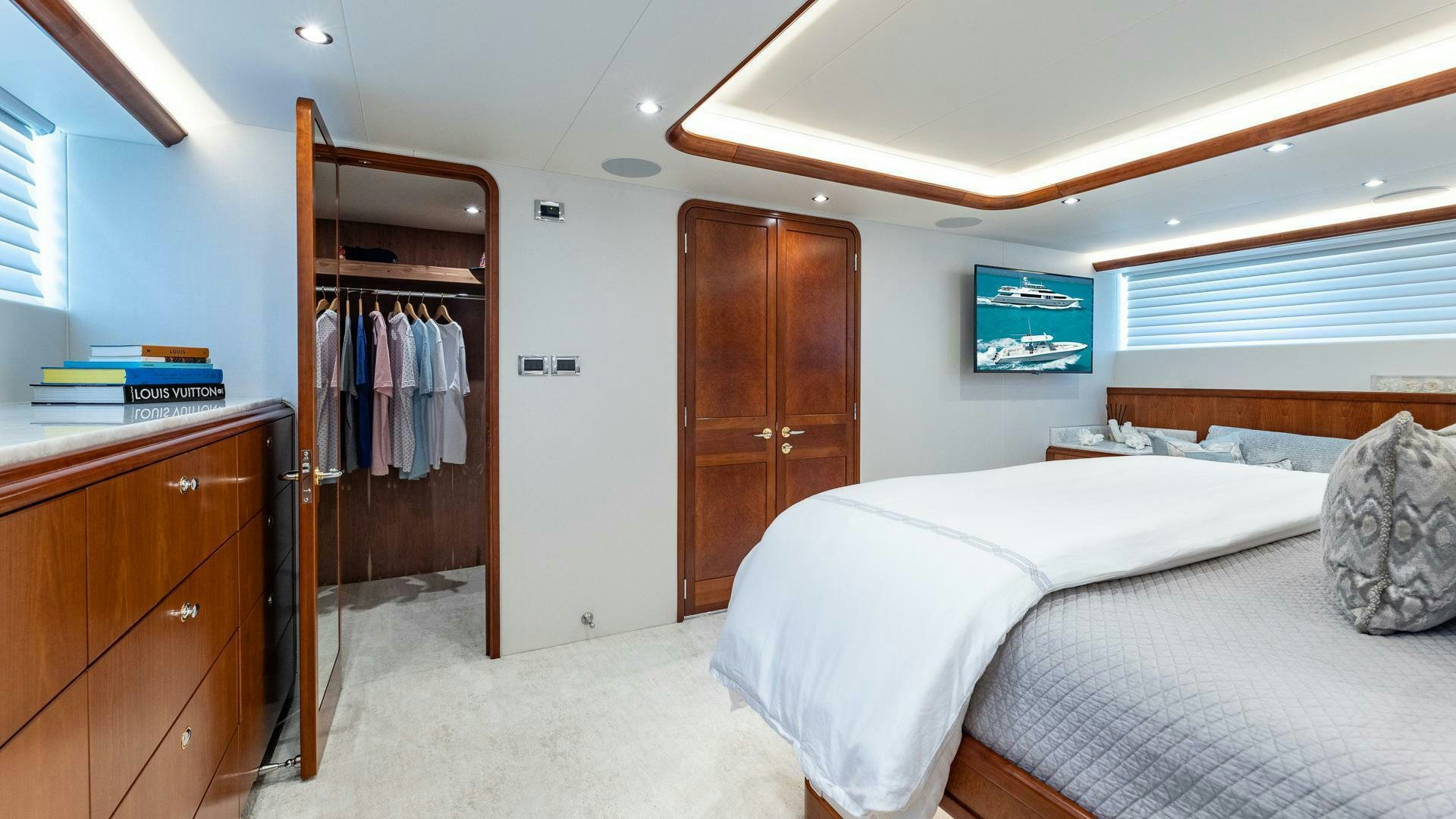 a bedroom with a closet and bed aboard NO SHORTCUTS Yacht for Sale
