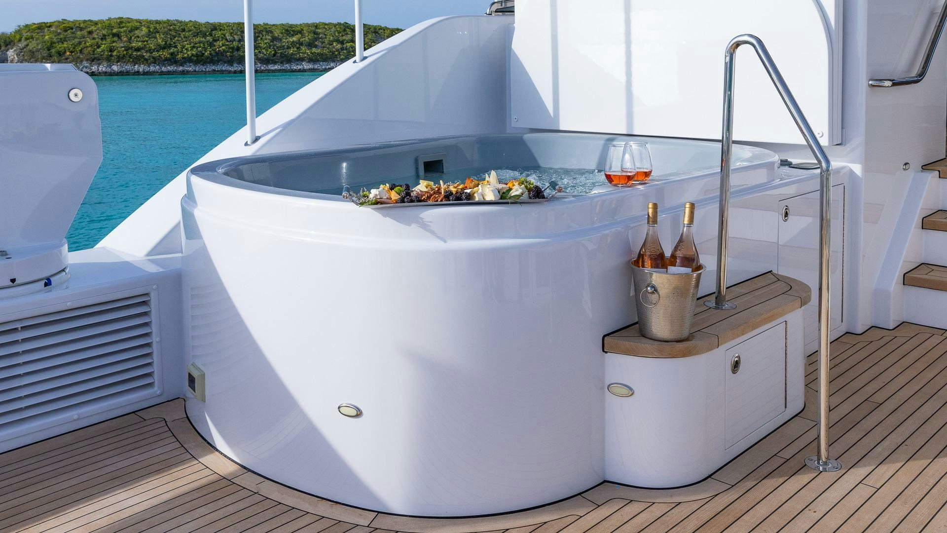 a white rectangular object with food on it by a pool aboard NO SHORTCUTS Yacht for Sale