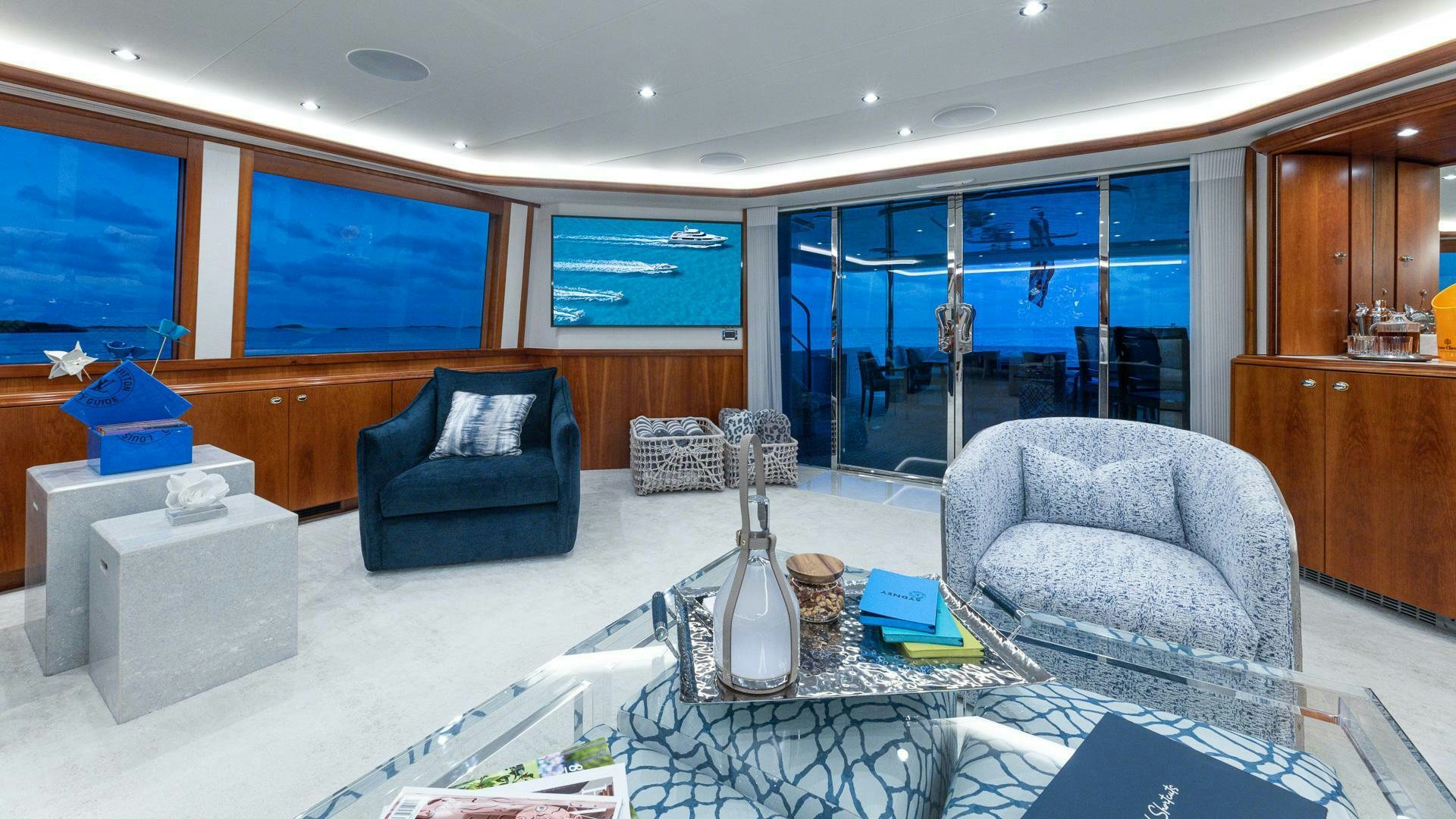 a living room with a glass wall aboard NO SHORTCUTS Yacht for Sale
