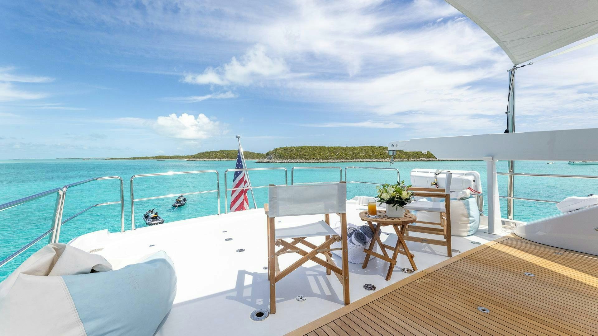 a deck with chairs and tables on it aboard NO SHORTCUTS Yacht for Sale
