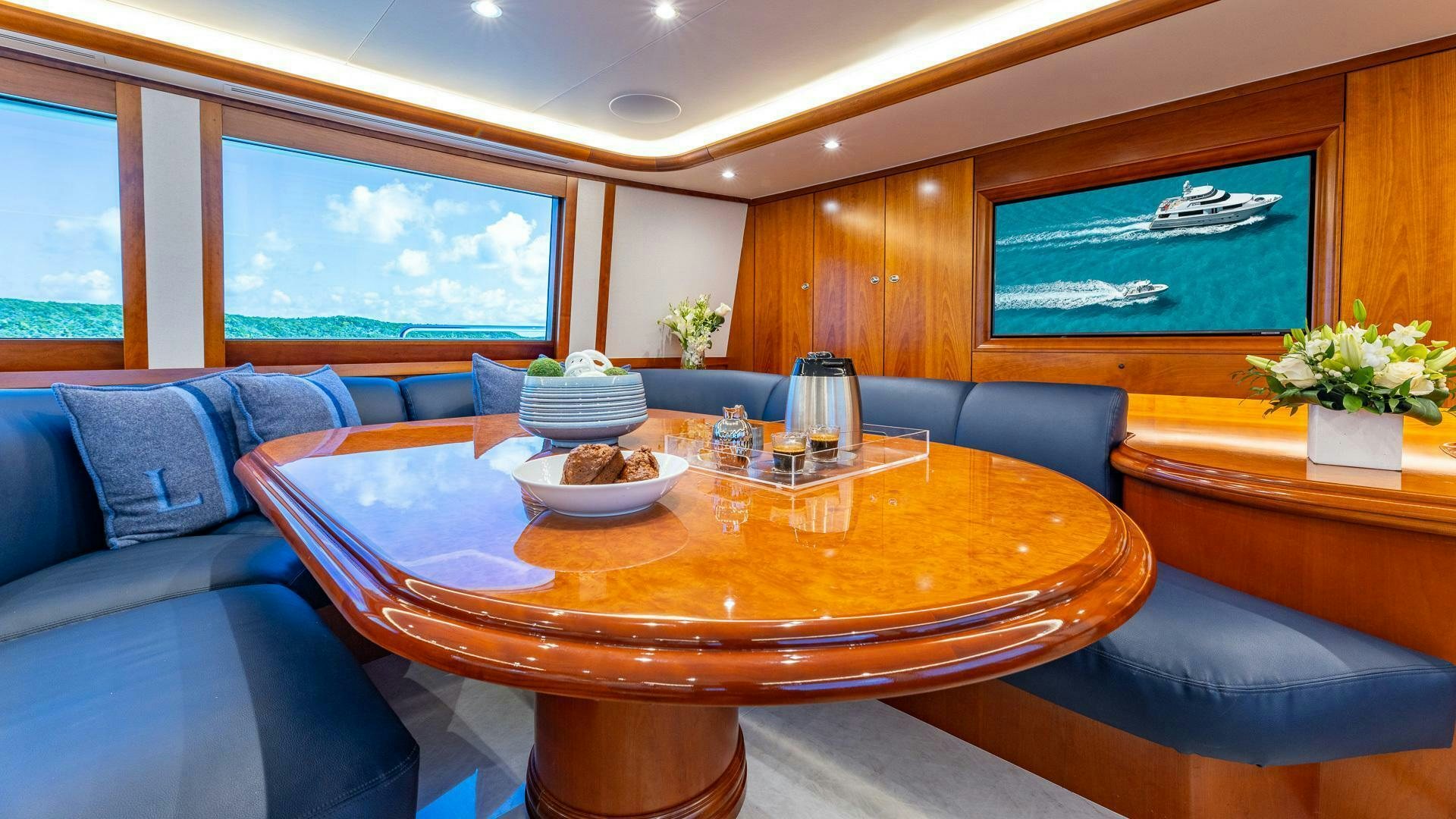 a table with plates and cups on it aboard NO SHORTCUTS Yacht for Sale