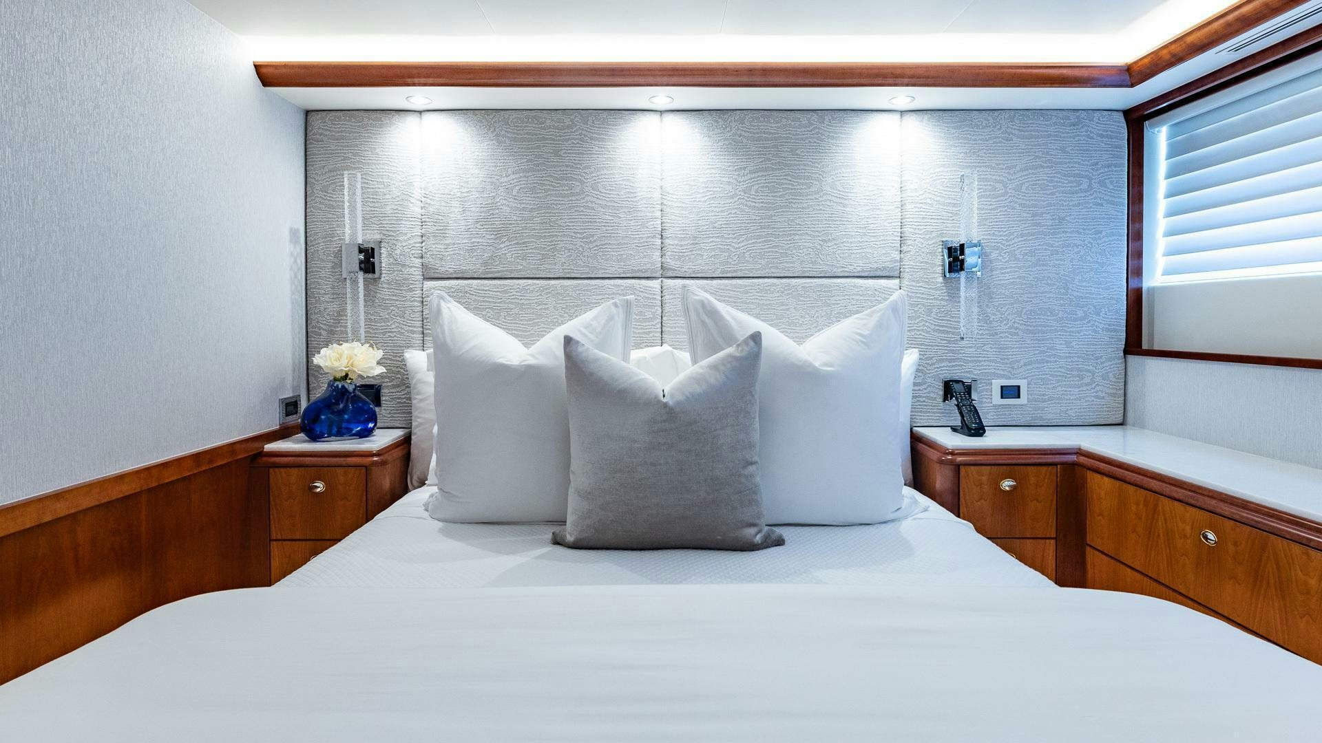 a bed with white sheets and pillows aboard NO SHORTCUTS Yacht for Sale