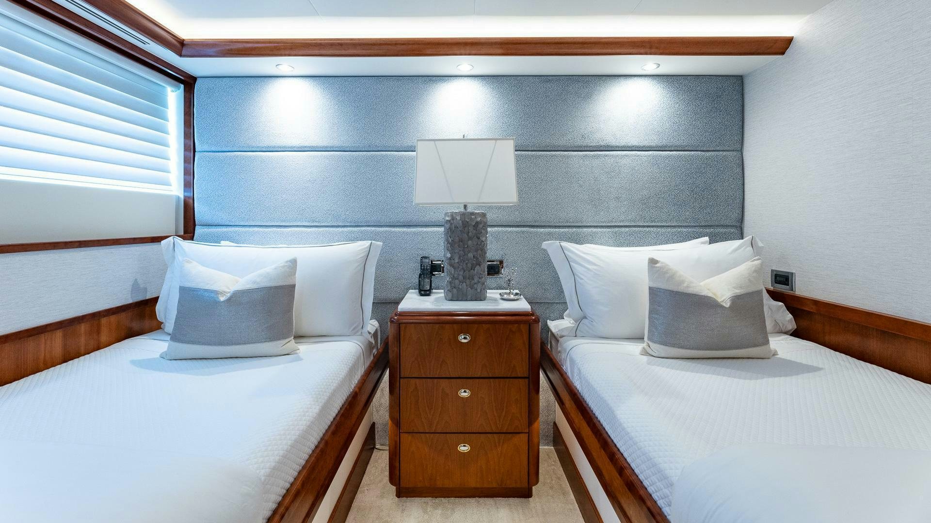 a room with a bed and a lamp aboard NO SHORTCUTS Yacht for Sale