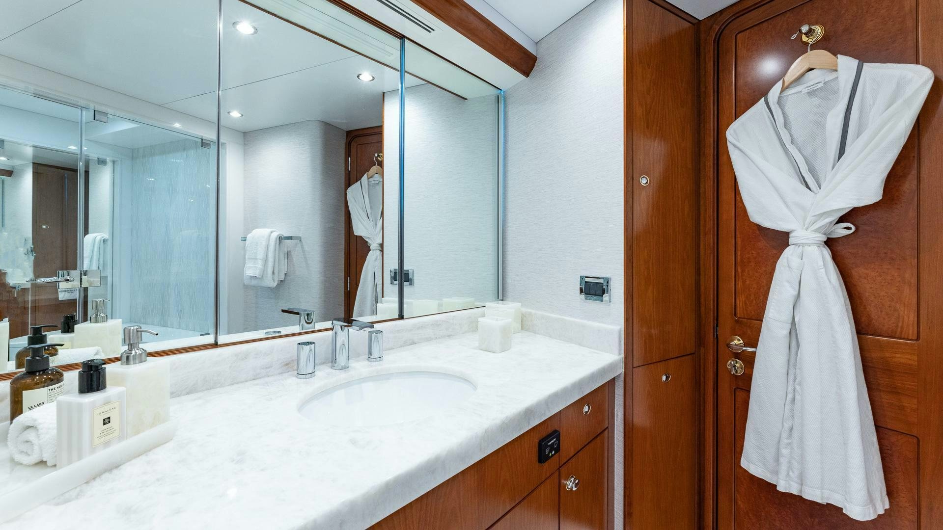 a bathroom with a dress on the wall aboard NO SHORTCUTS Yacht for Sale