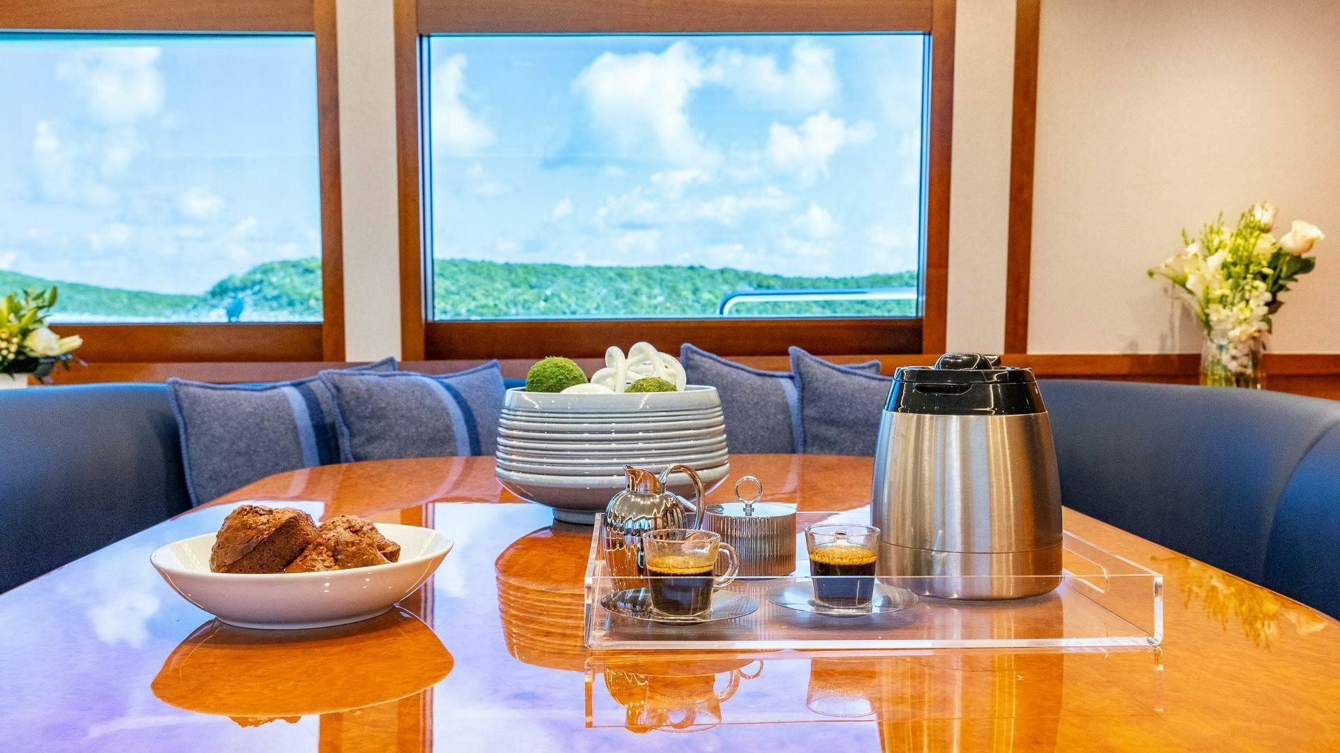 a table with food and drinks on it aboard NO SHORTCUTS Yacht for Sale