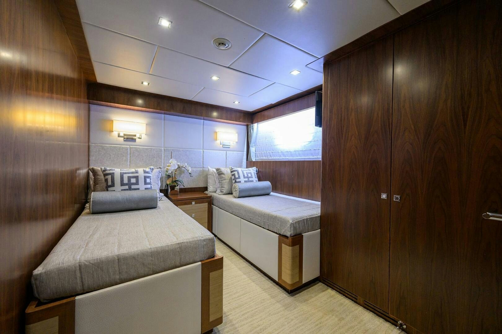 a room with a bed and a wood cabinet aboard SECOND AMENDMENT Yacht for Sale