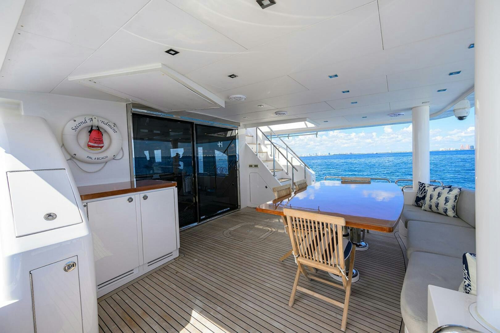 a boat with a deck and a table and chairs aboard SECOND AMENDMENT Yacht for Sale