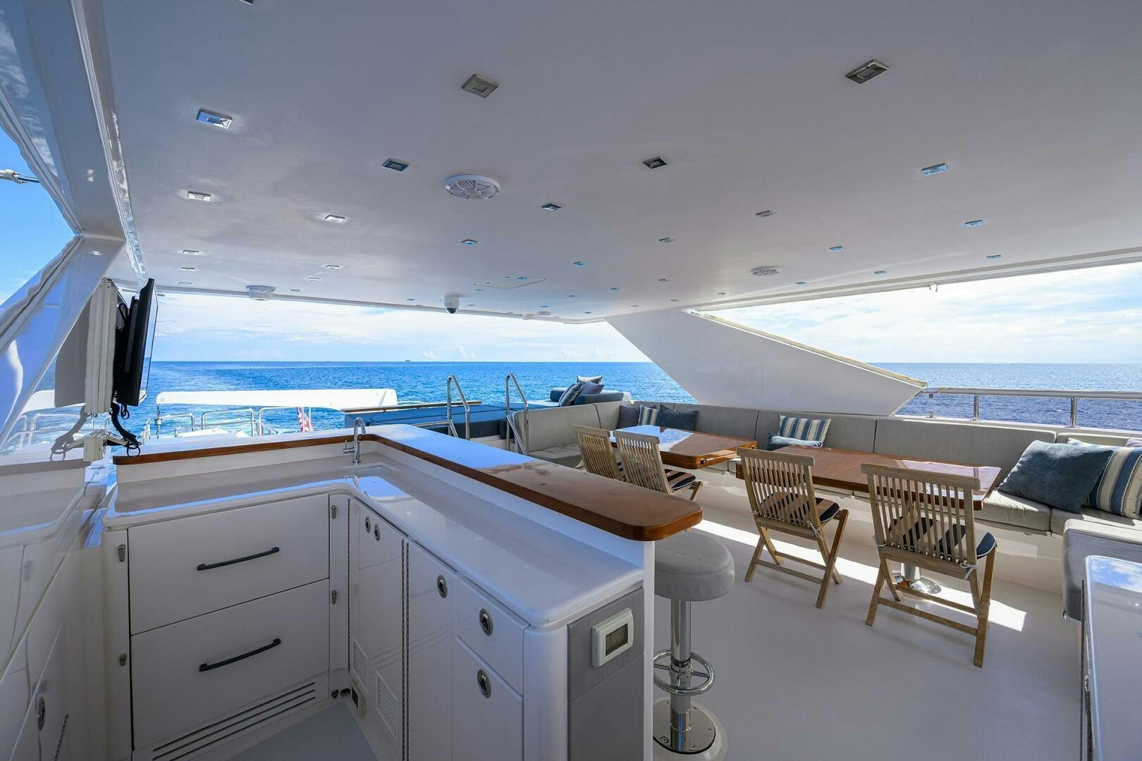 a room with a large white table and chairs and a large window aboard SECOND AMENDMENT Yacht for Sale