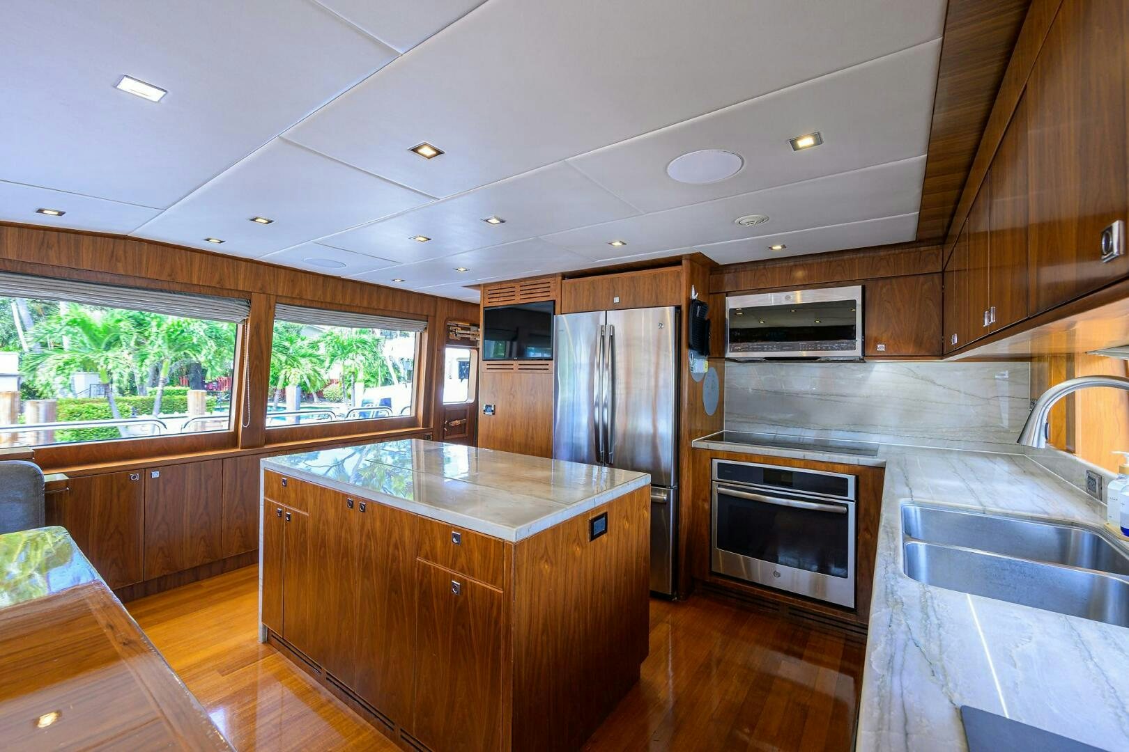 a kitchen with wooden cabinets aboard SECOND AMENDMENT Yacht for Sale