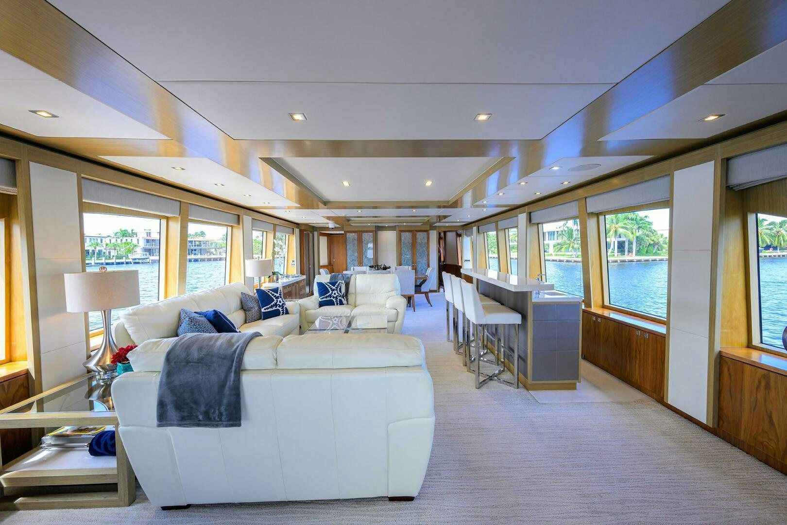 a large living room with a large white couch and a large window aboard SECOND AMENDMENT Yacht for Sale