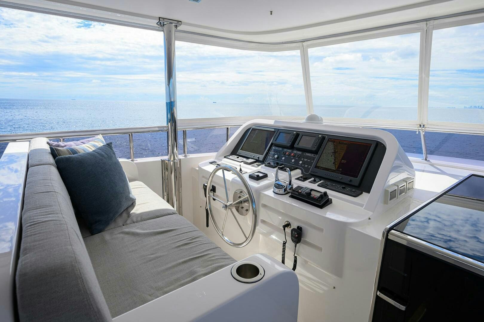 a room with a bed and a white bed and a white sofa aboard SECOND AMENDMENT Yacht for Sale