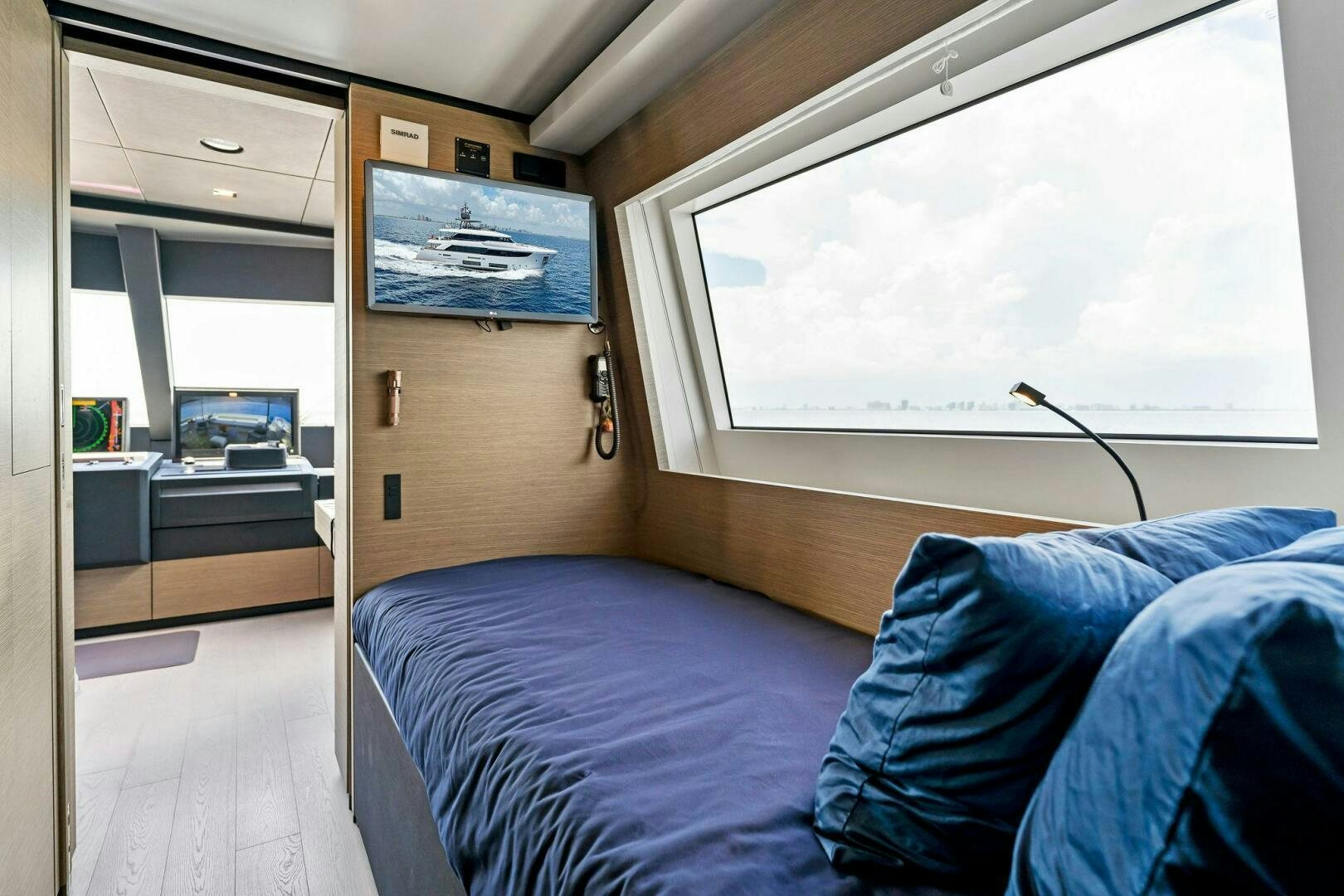 a bedroom with a bed and a desk aboard FAMILIA Yacht for Sale