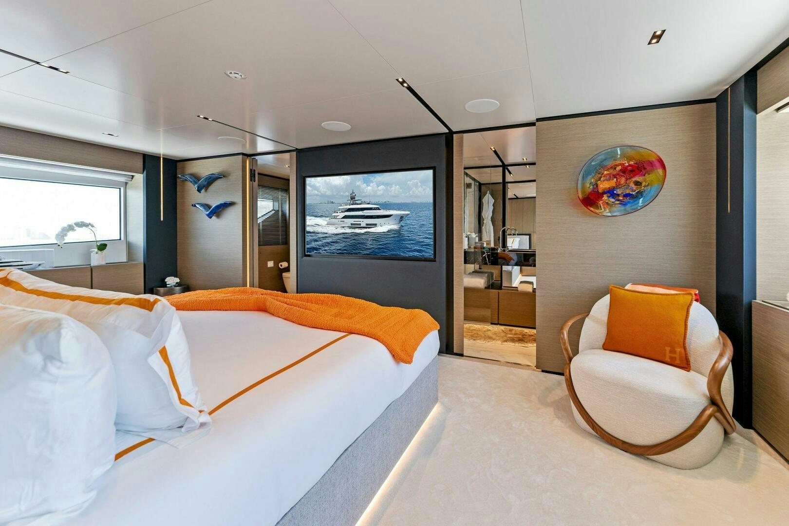 a bedroom with a bed and a chair aboard FAMILIA Yacht for Sale