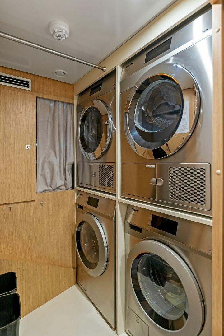 a room with a washing machine and dryer aboard FAMILIA Yacht for Sale