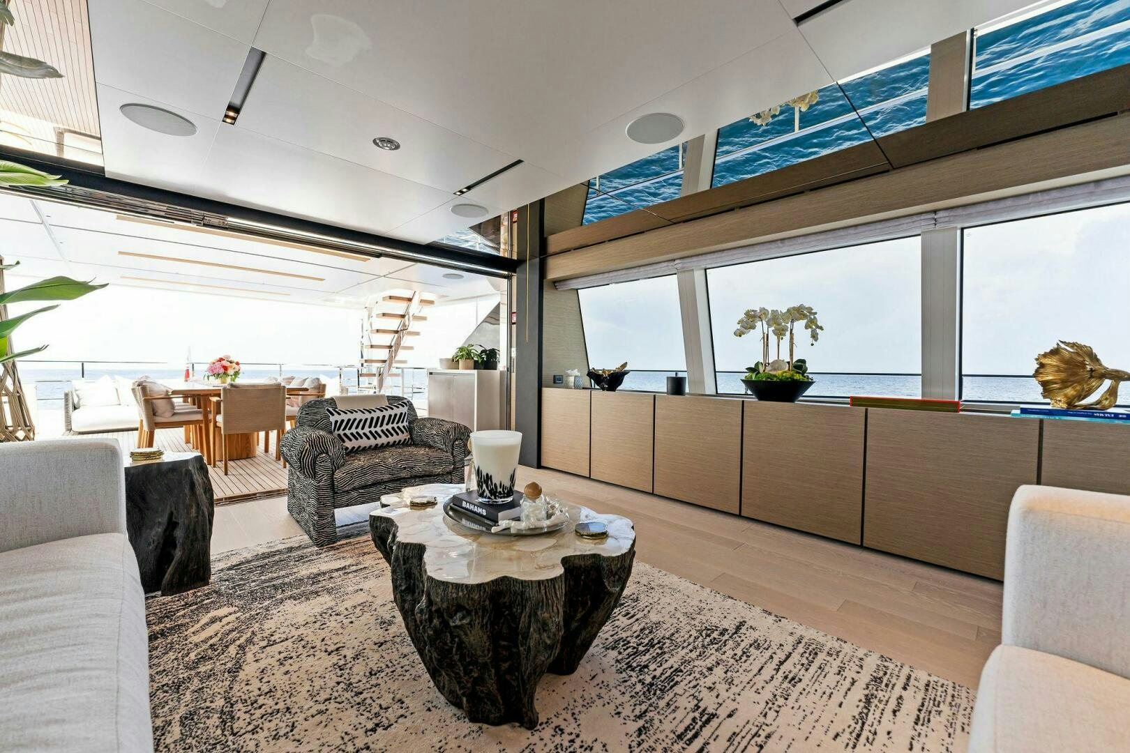 a room with a couch and a table and chairs aboard FAMILIA Yacht for Sale