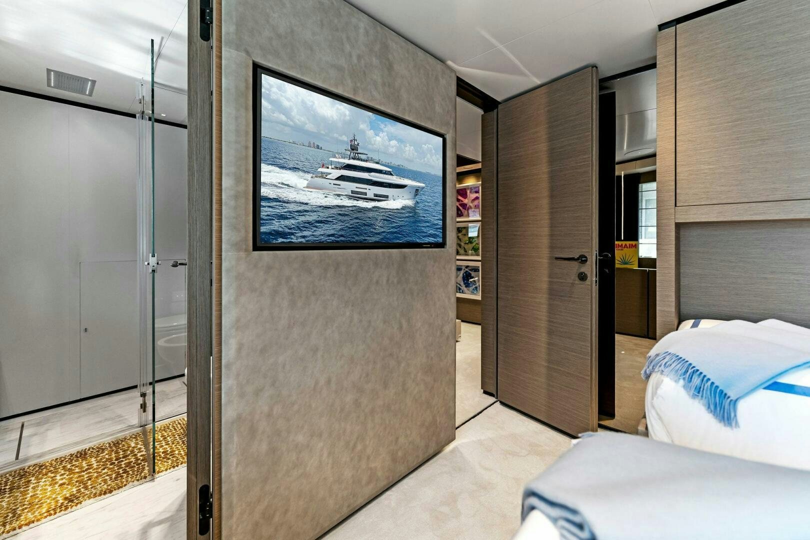 a room with a bed and a tv on the wall aboard FAMILIA Yacht for Sale