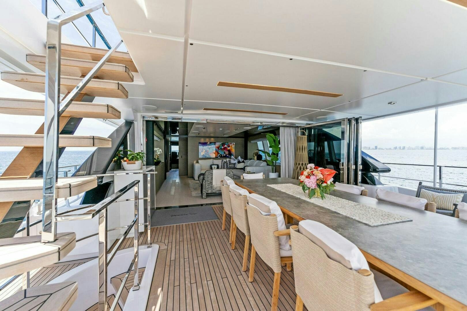 a modern looking living room with a large open window aboard FAMILIA Yacht for Sale