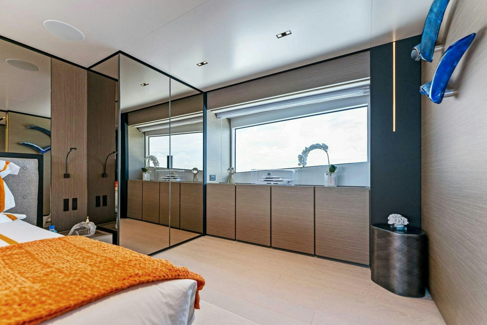 a bedroom with a large mirror aboard FAMILIA Yacht for Sale