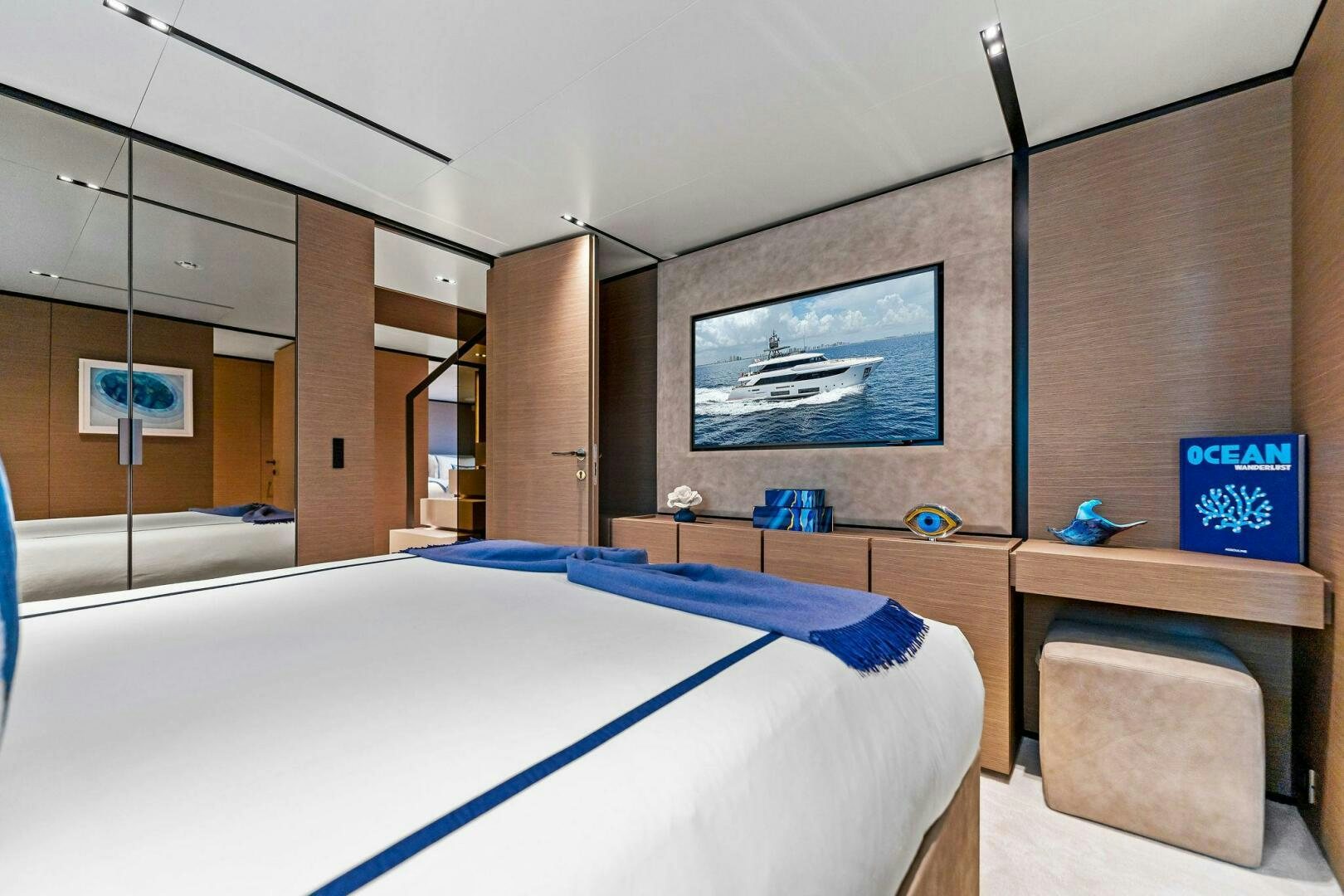 a room with a bed and a tv on the wall aboard FAMILIA Yacht for Sale