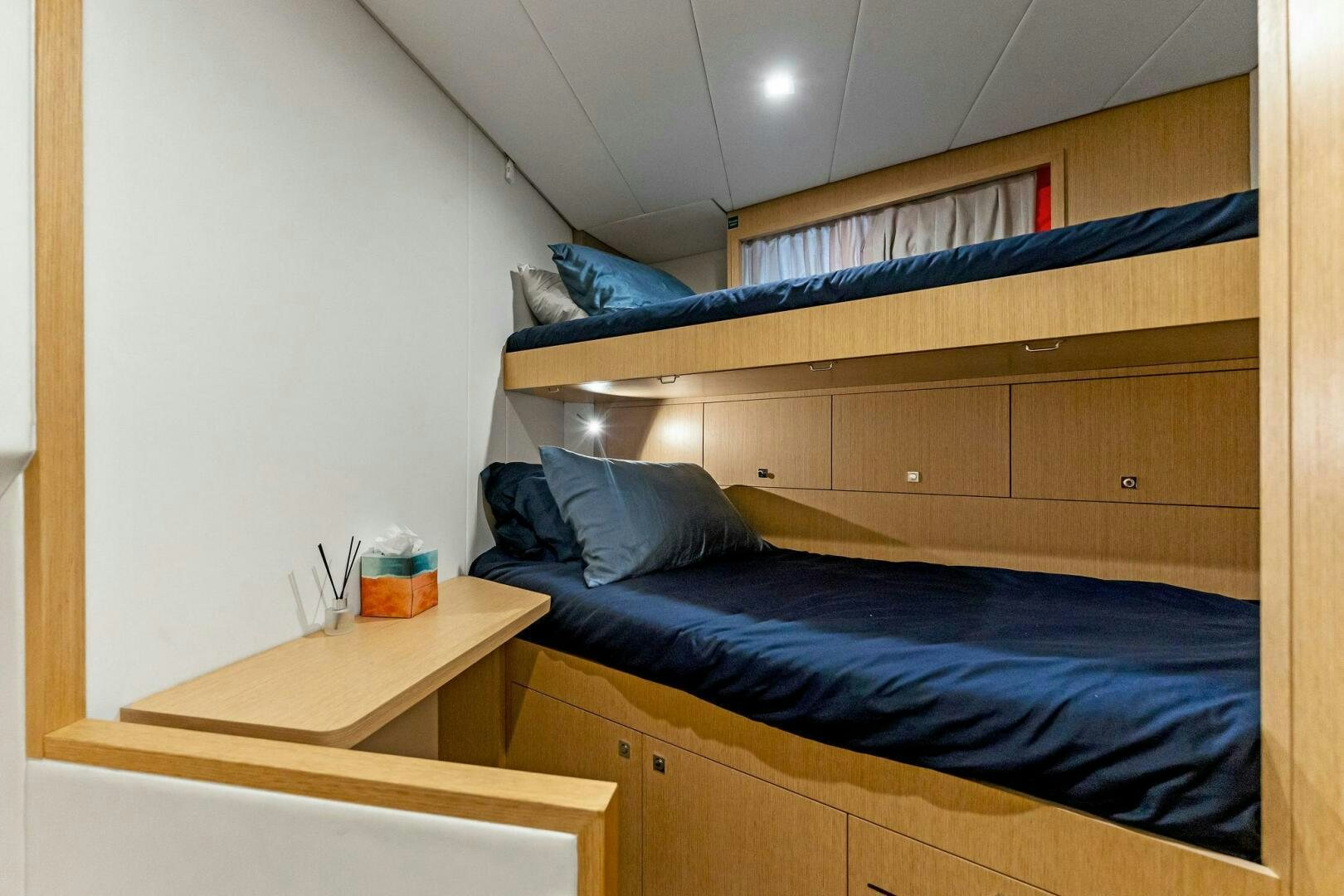 a room with bunk beds aboard FAMILIA Yacht for Sale