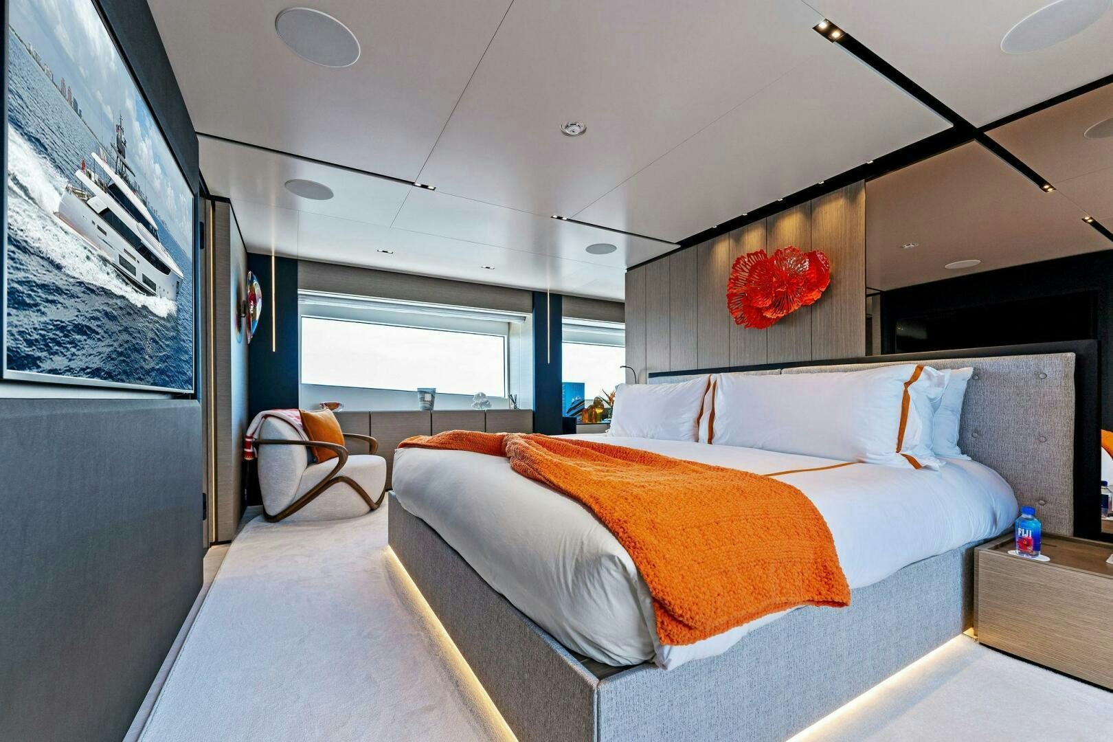 a bedroom with a bed and a chair aboard FAMILIA Yacht for Sale