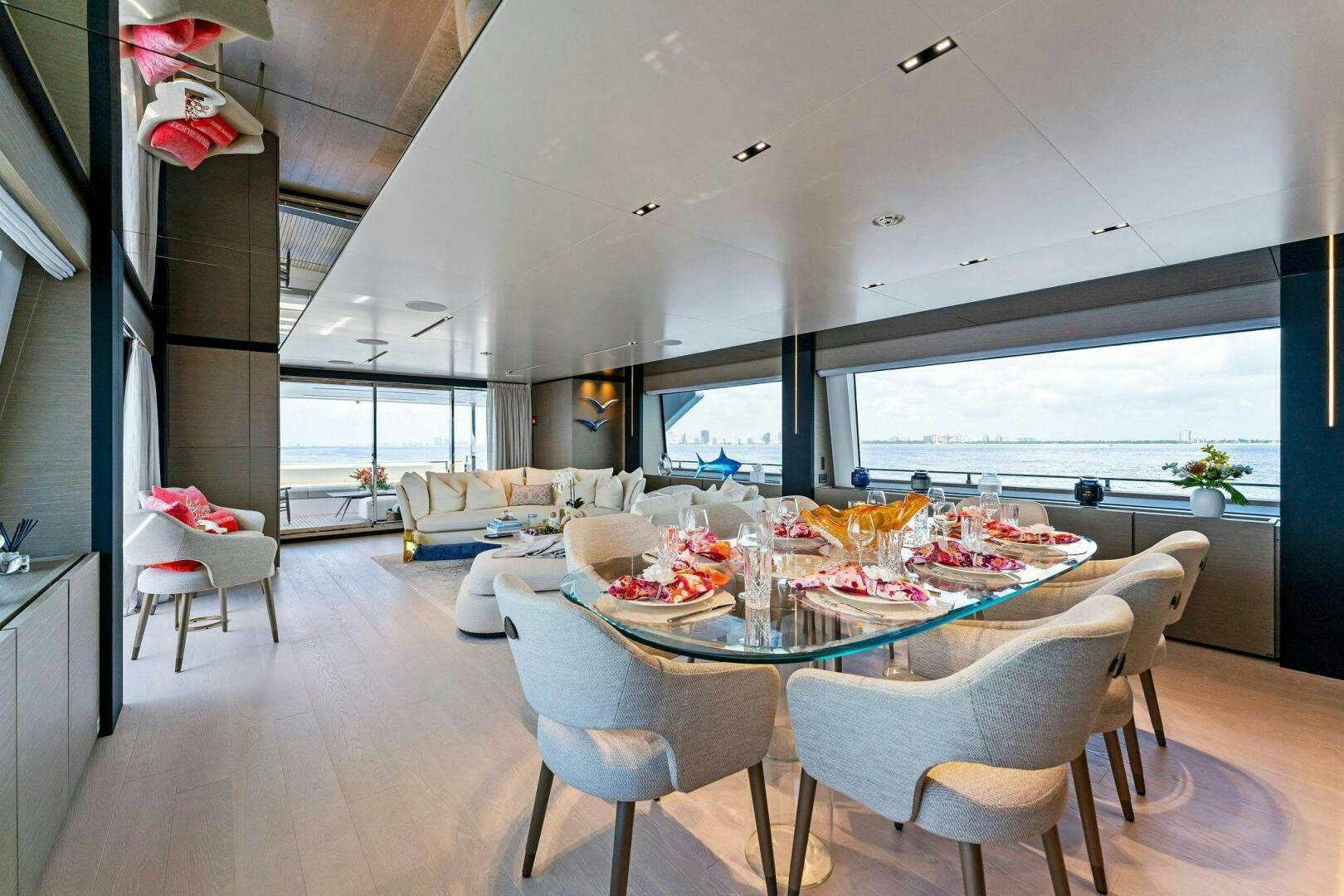 a dining room with a large window aboard FAMILIA Yacht for Sale