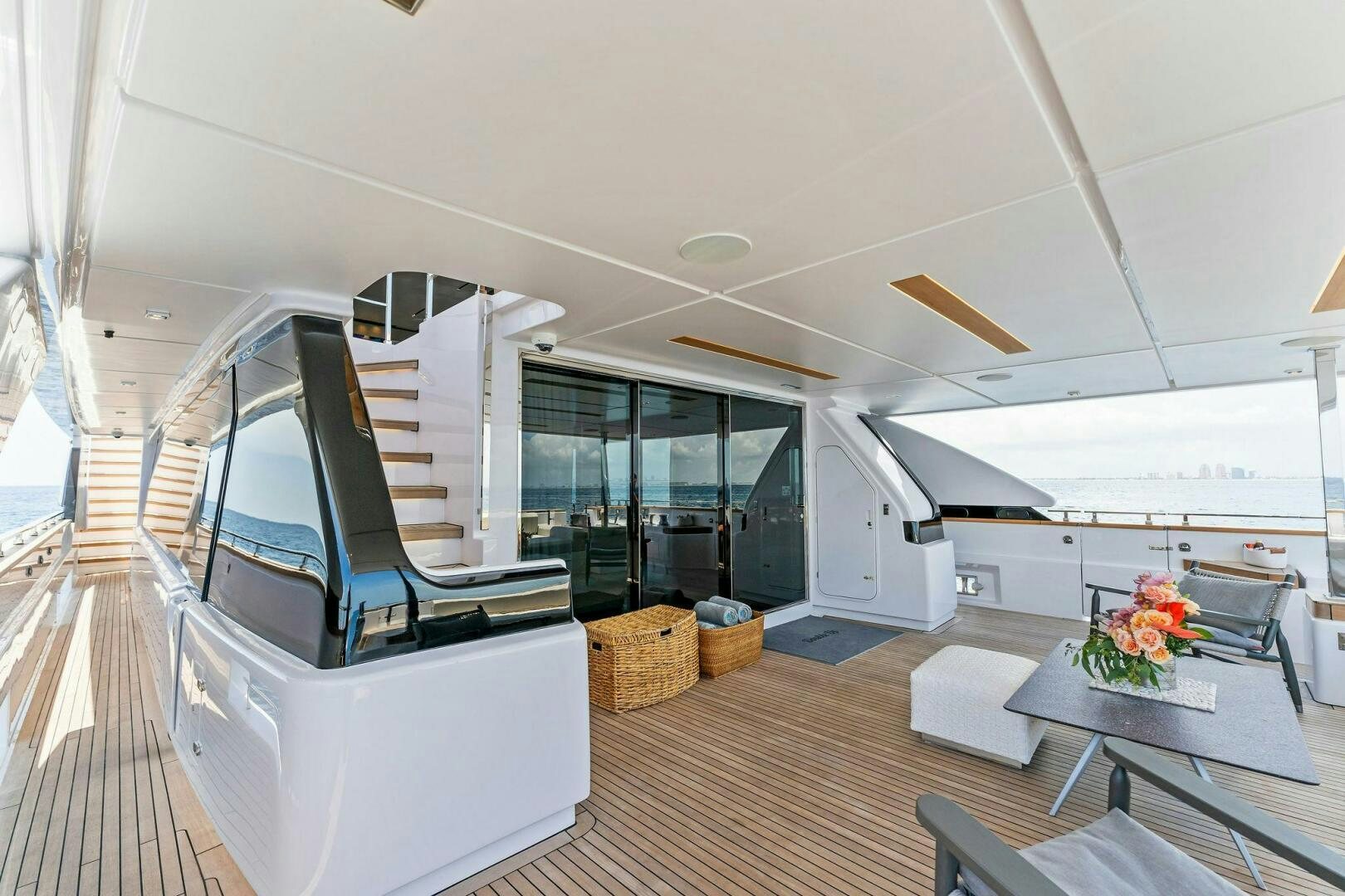 a room with a staircase and a table and chairs aboard FAMILIA Yacht for Sale