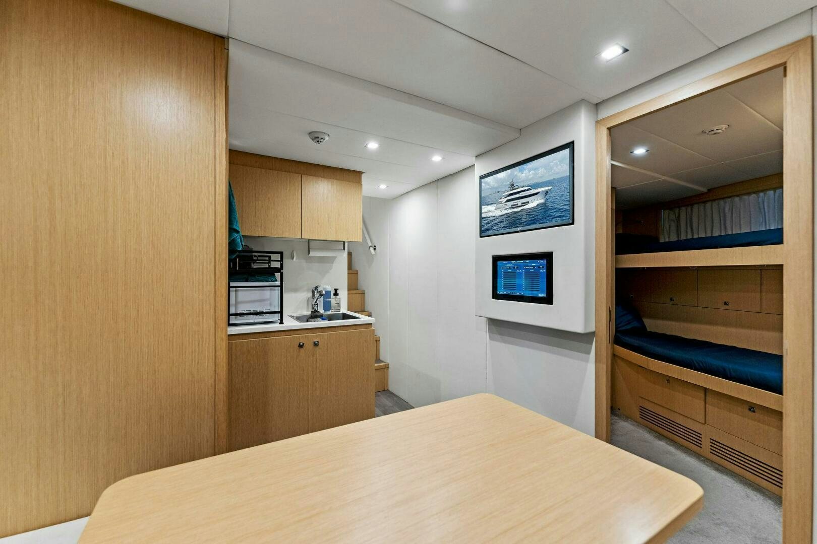a room with a bed and a desk aboard FAMILIA Yacht for Sale