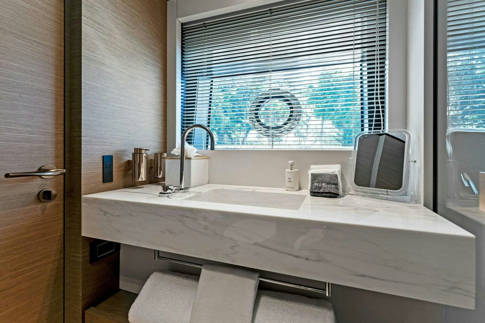 a bathroom with a sink and a window aboard FAMILIA Yacht for Sale