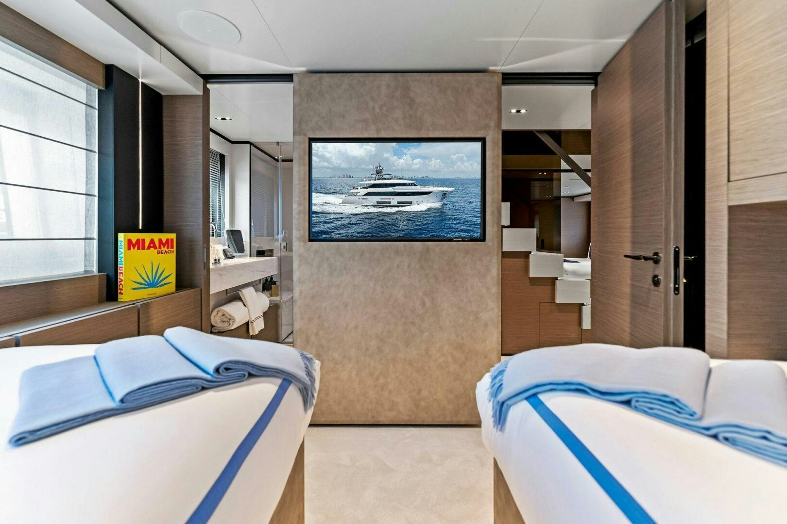 a room with beds and a painting aboard FAMILIA Yacht for Sale