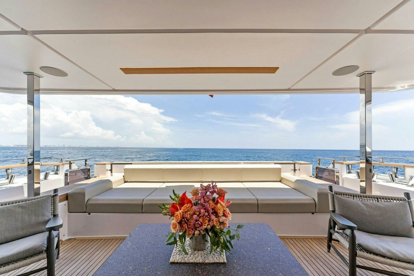 a vase of flowers on a table aboard FAMILIA Yacht for Sale