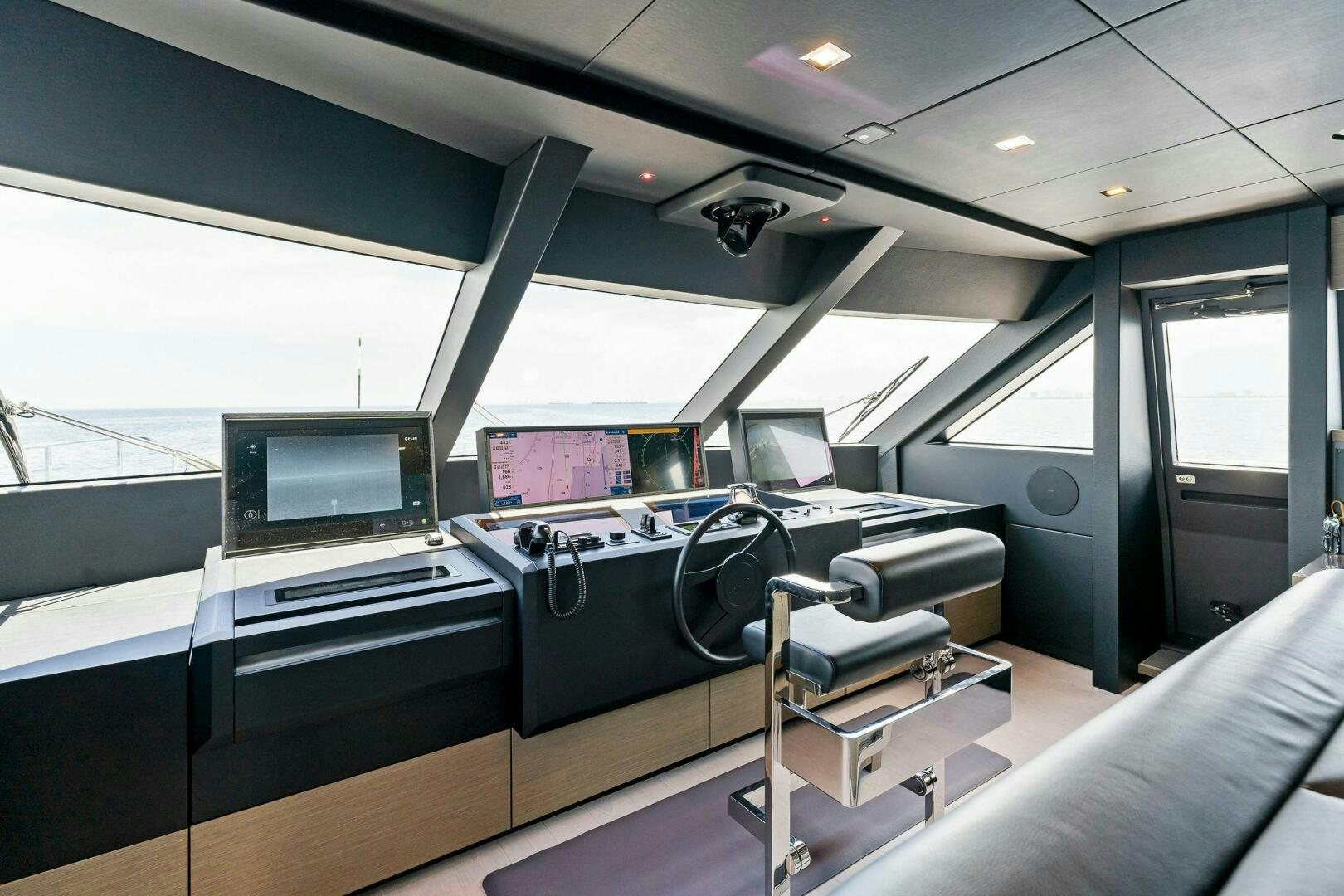 a room with a desk and chairs aboard FAMILIA Yacht for Sale