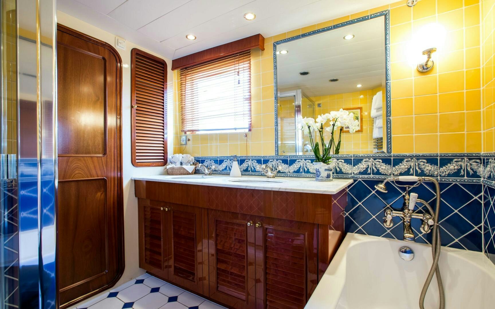 a bathroom with a tub sink and cabinets aboard STAR OF THE SEA Yacht for Sale