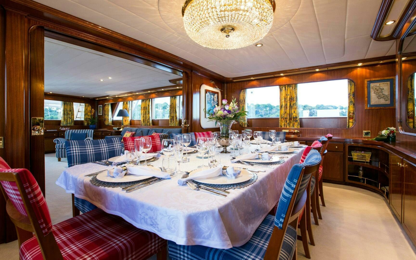 a dining room with a table set for a dinner aboard STAR OF THE SEA Yacht for Sale