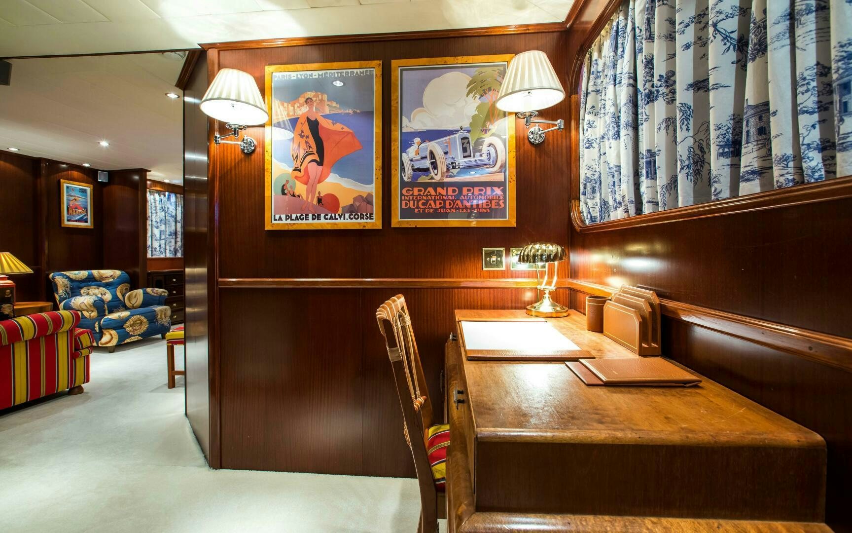 a room with a desk and a bed aboard STAR OF THE SEA Yacht for Sale