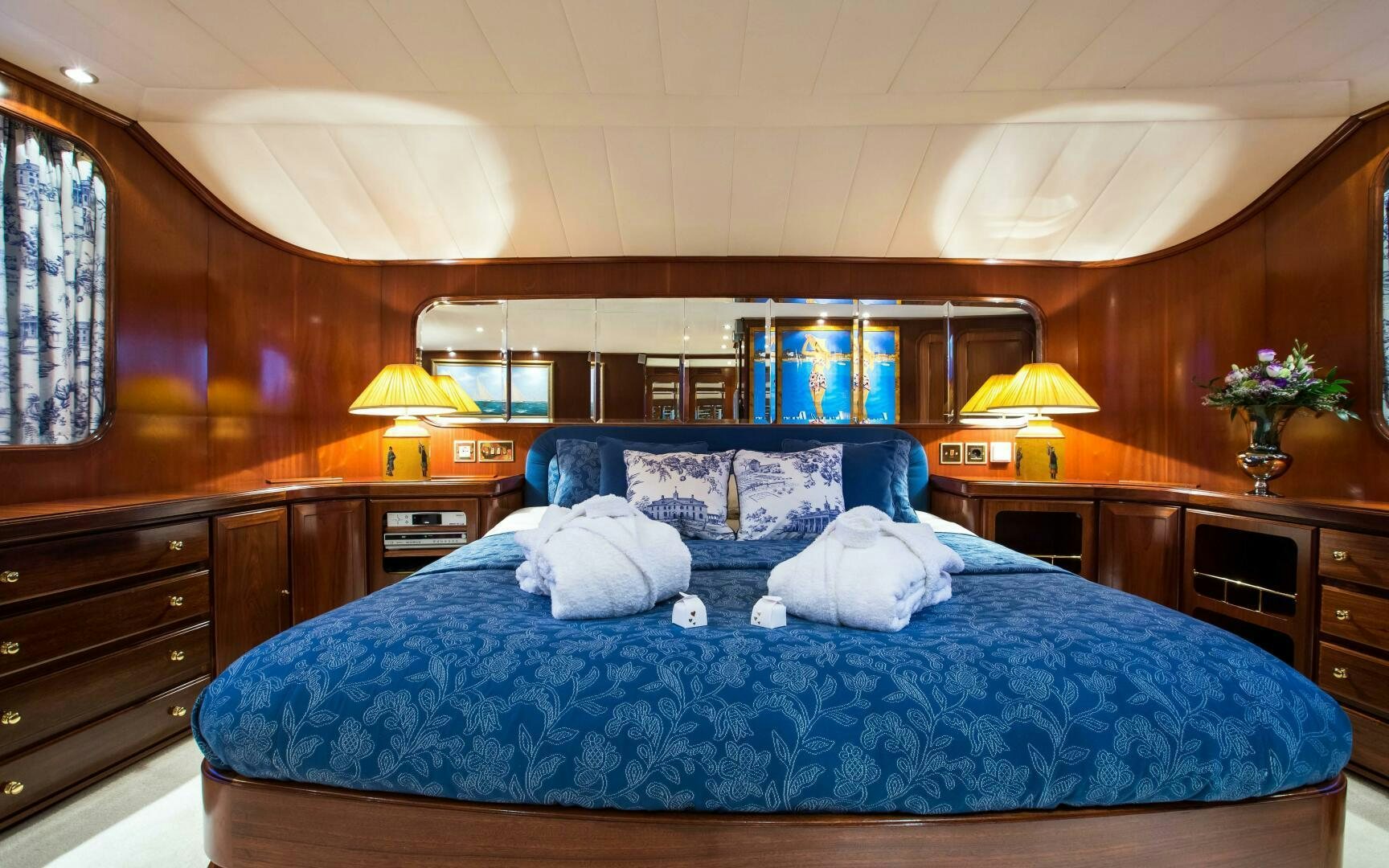 a bed with a blue blanket aboard STAR OF THE SEA Yacht for Sale