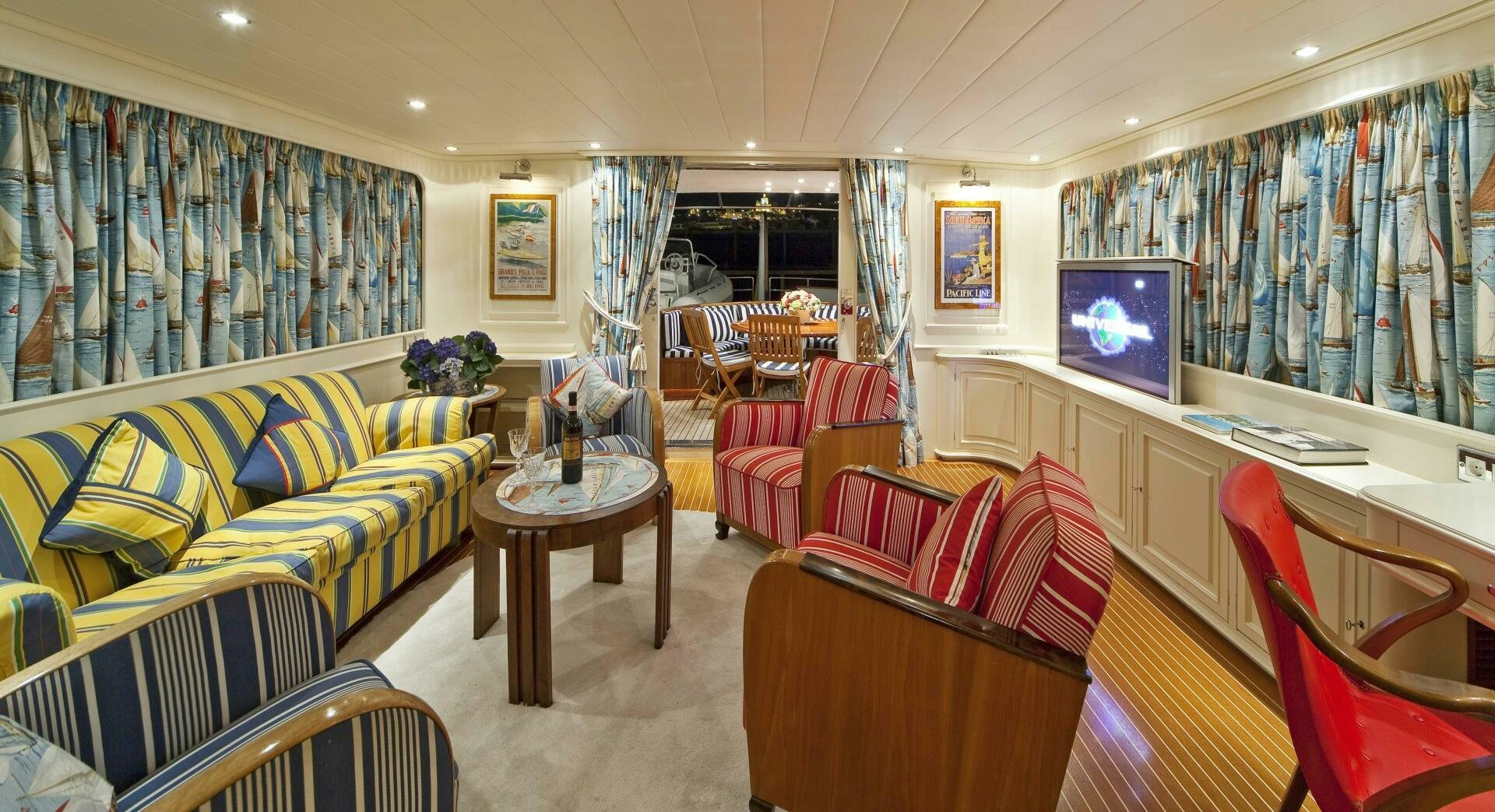 a living room with a couch and a television aboard STAR OF THE SEA Yacht for Sale